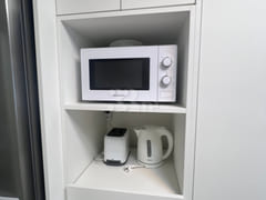 Fully furnished white-themed room in Junghwas 8th image