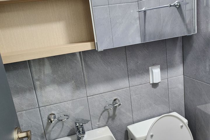 Clean white and gray studio apartment 5th image
