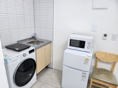 Clean white and gray studio apartment 3th image