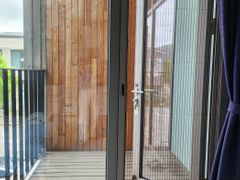 A glass-walled room with a terrace 17th image