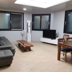 A house with a view of the sea and a lighthou Unit Image