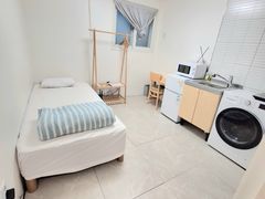Clean, modern white studio apartment 11th image