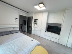 Fully furnished white-themed room in Junghwas 6th image