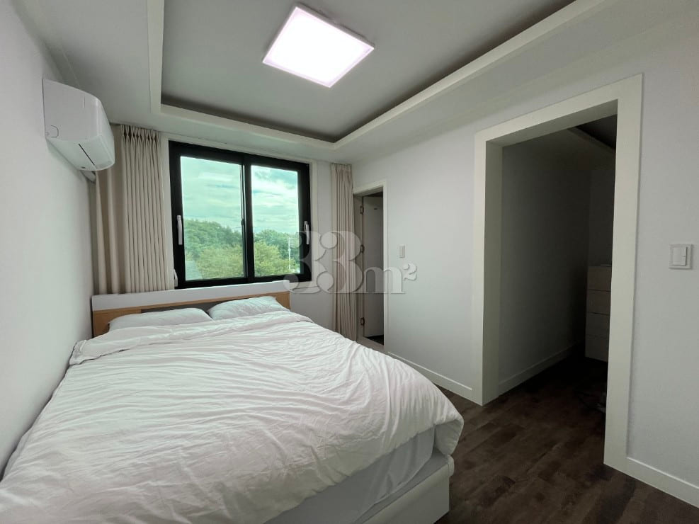 3rd-floor unit facing a park with a forest vi 3th image
