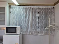 A cozy room with plenty of sunshine. 8th image