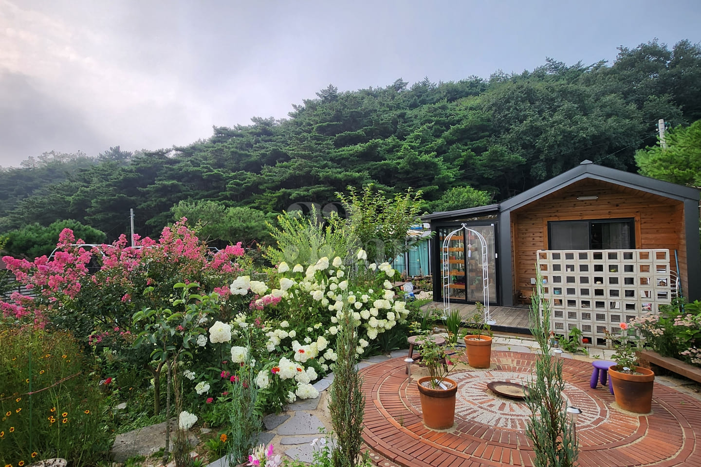 A room with a pretty garden in the forest. 0th image