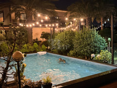 A house with a swimming pool and a yard 9th image
