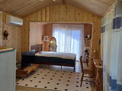 A room with a pretty garden in the forest. 16th image