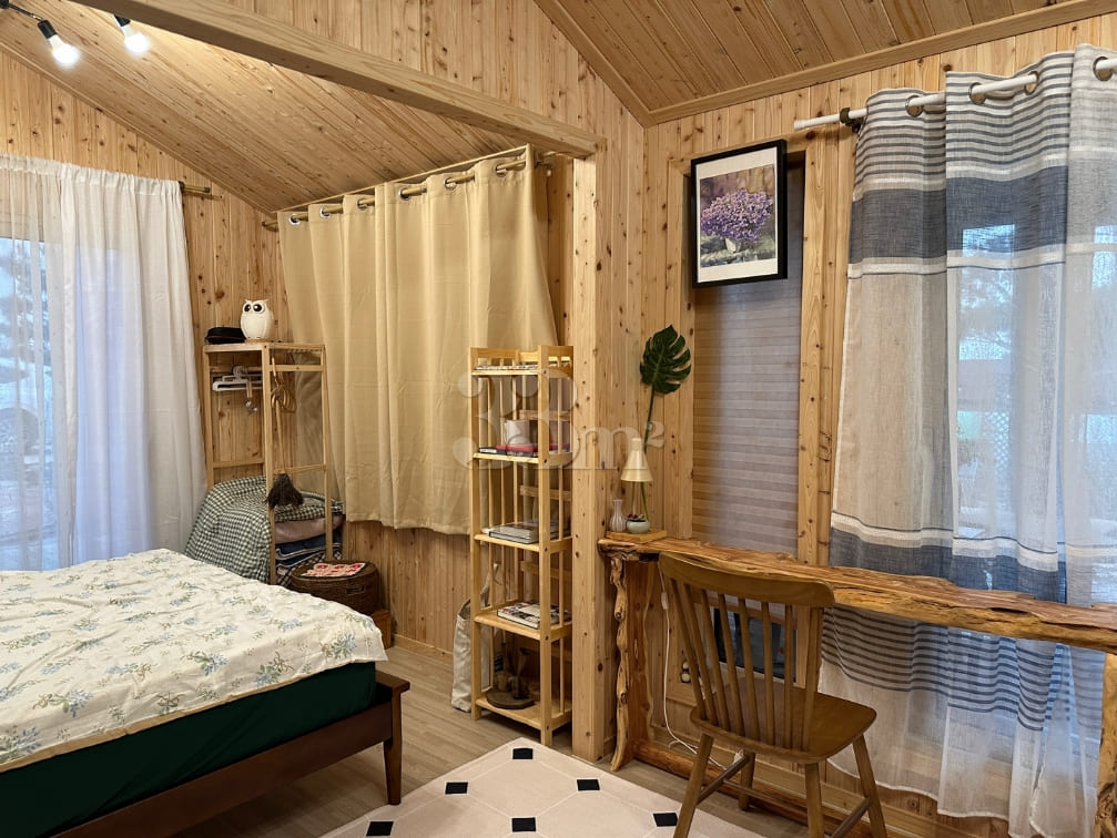 A room with a pretty garden in the forest. 6th image