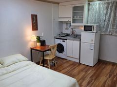 A cozy room with plenty of sunshine. 3th image