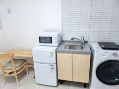 Clean, modern white studio apartment 6th image