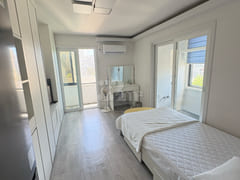 Fully furnished white-themed room in Junghwas 16th image
