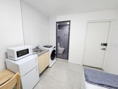 Clean, modern white studio apartment 8th image