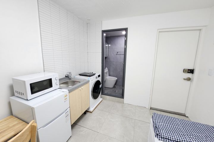 Clean, modern white studio apartment 8th image