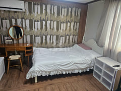 It is a studio apartment with a kitchen. 1th image