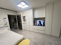 Fully furnished white-themed room in Junghwas 15th image
