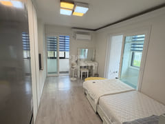 Fully furnished white-themed room in Junghwas 4th image