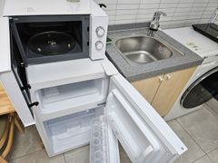 Clean, modern white studio apartment 12th image
