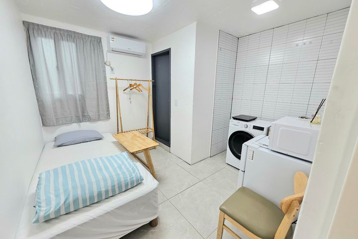 Clean white and gray studio apartment 0th image