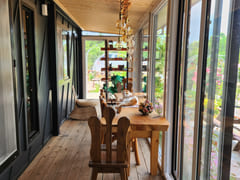 A room with a pretty garden in the forest. 2th image