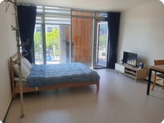 A glass-walled room with a terrace 0th image