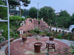 A room with a pretty garden in the forest. 15th image
