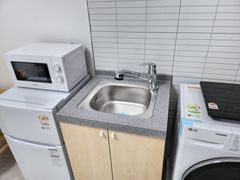 Clean, modern white studio apartment 4th image