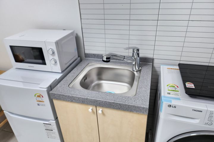 Clean, modern white studio apartment 4th image
