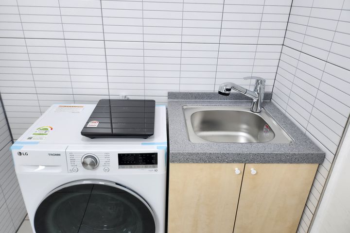 Clean white and gray studio apartment 4th image
