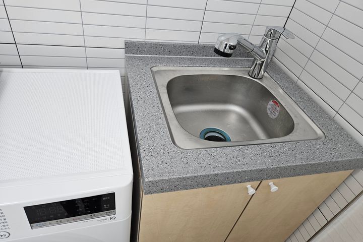 Clean white and gray studio apartment 11th image