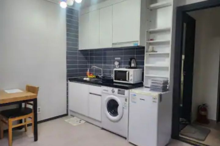 A glass-walled room with a terrace 4th image