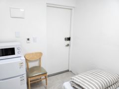 Clean white and gray studio apartment 2th image