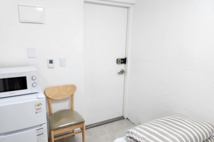 Clean white and gray studio apartment 2th image