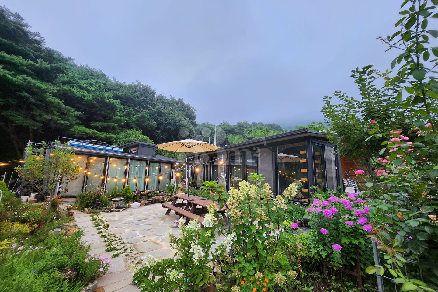 A room with a pretty garden in the forest. 1th image