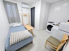 Clean white and gray studio apartment 13th image