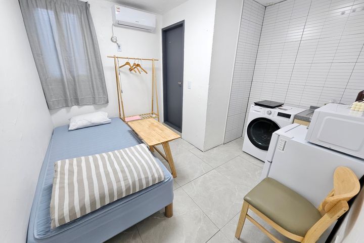 Clean white and gray studio apartment 13th image