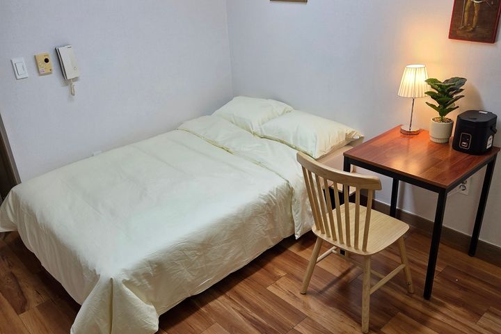 A cozy room with plenty of sunshine. 1th image