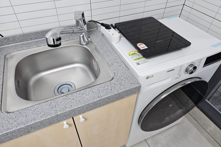 Clean, modern white studio apartment 10th image