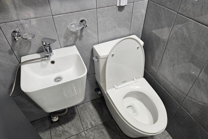 Clean white and gray studio apartment 15th image