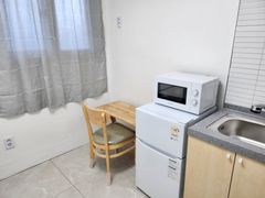 Clean, modern white studio apartment 5th image