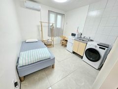 Clean, modern white studio apartment 0th image
