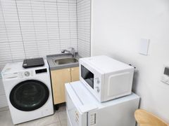 Clean white and gray studio apartment 8th image