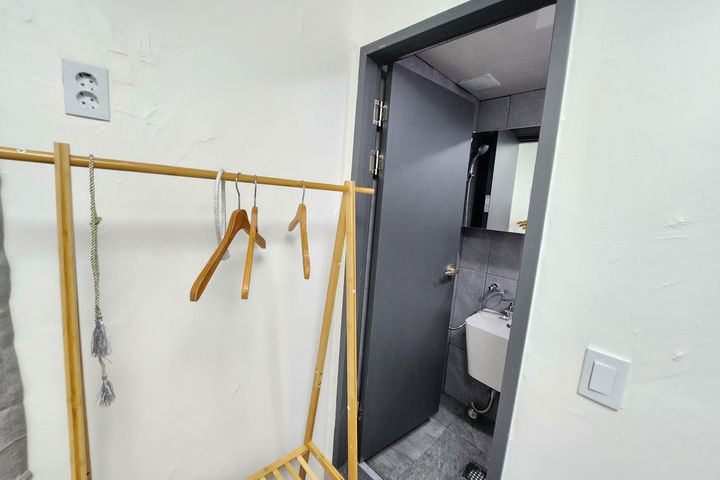 Clean white and gray studio apartment 7th image